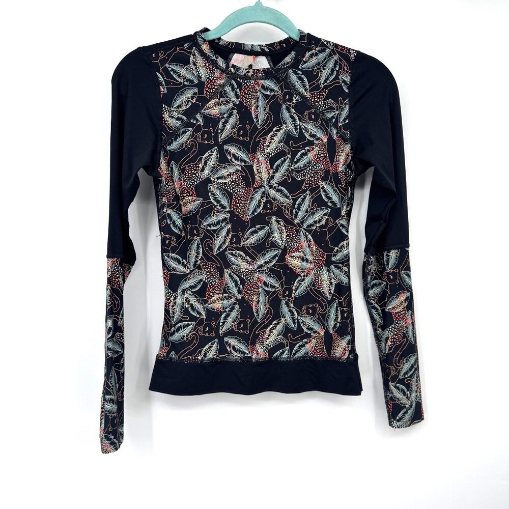 activewear long-sleeved top with a black background and a pattern of leaves and